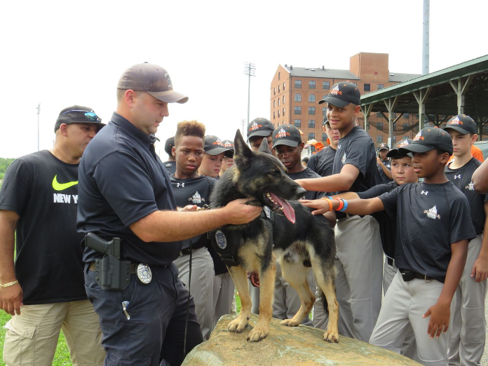 Young baseball players greet police dog